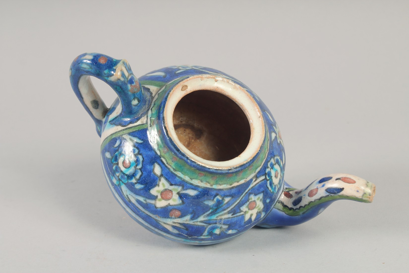 A PALISTINIAN GLAZED POTTERY TEAPOT, with foliate decoration, 19cm spout to handle. - Image 6 of 7