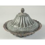 AN ISLAMIC TINNED COPPER DISH AND COVER, 21cm diameter.