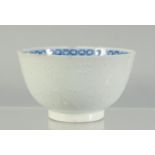 A SMALL CHINESE BLUE AND WHITE BOWL, the exterior with carved decoration, (faults) 9cm.