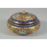 A CLOISONNE PART-ENAMELLED GILT CIRCULAR LIDDED BOX, with raised floral decoration, 15cm diameter.