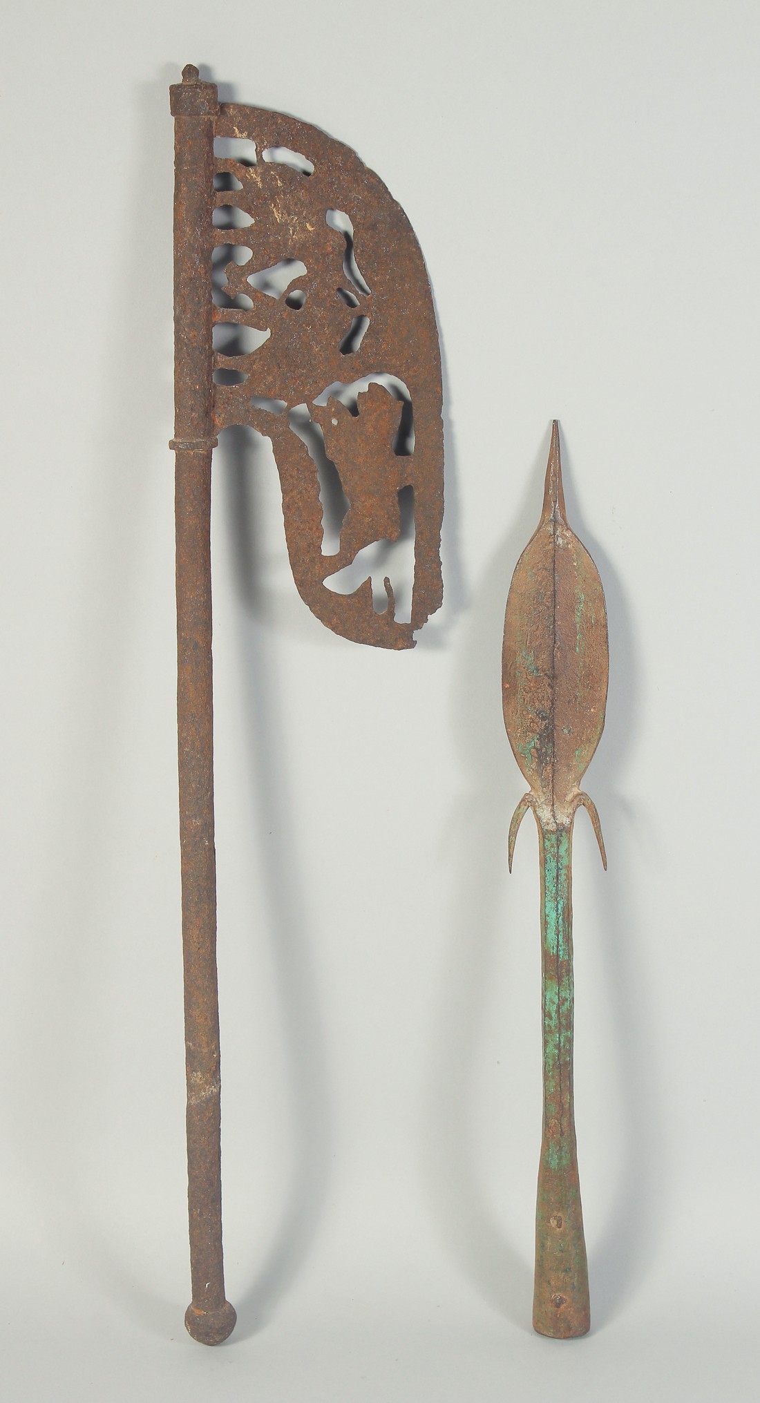 AN 18TH CENTURY INDIAN IRON AXE HEAD with openwork animal decoration, 64cm long, together with an
