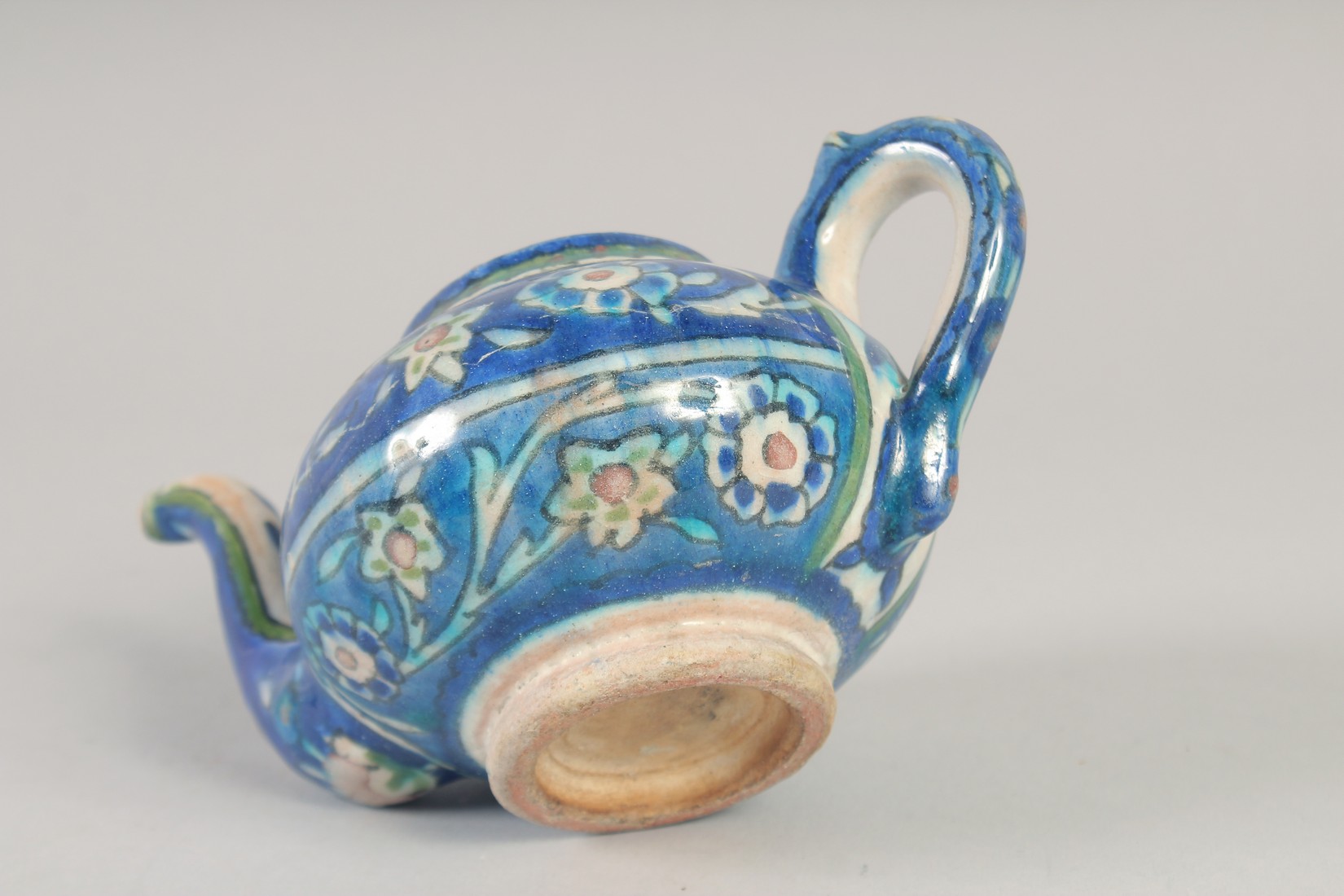 A PALISTINIAN GLAZED POTTERY TEAPOT, with foliate decoration, 19cm spout to handle. - Image 7 of 7