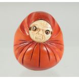 A SMALL JAPANESE KOBE TOY, with carved bone face and pop-out eyes, 4cm.