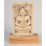 AN 18TH-19TH CENTURY THAI CARVED BONE PANEL, depicting Buddha, mounted to a wooden base, panel 9cm x