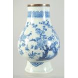 A CHINESE TRANSITIONAL BLUE AND WHITE PORCELAIN VASE, painted with flora, (neck cut with silver