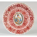 A QAJAR RED AND WHITE PORCELAIN PLATE, with central portrait medallion and foliate decoration, 26.