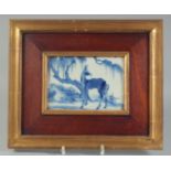 A FINE 19TH CENTURY CHINESE FRAMED BLUE AND WHITE PORCELAIN PANEL, painted with a horse in a