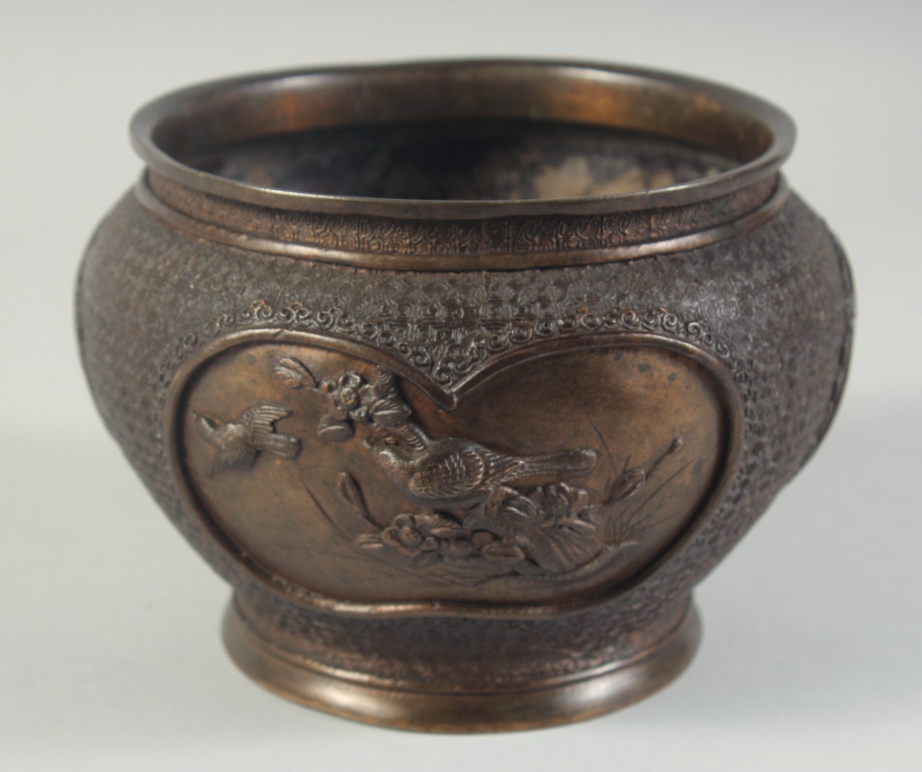 A BRONZE CACHE POT / KORO, decorated with panels of relief birds, character mark to base, 18cm