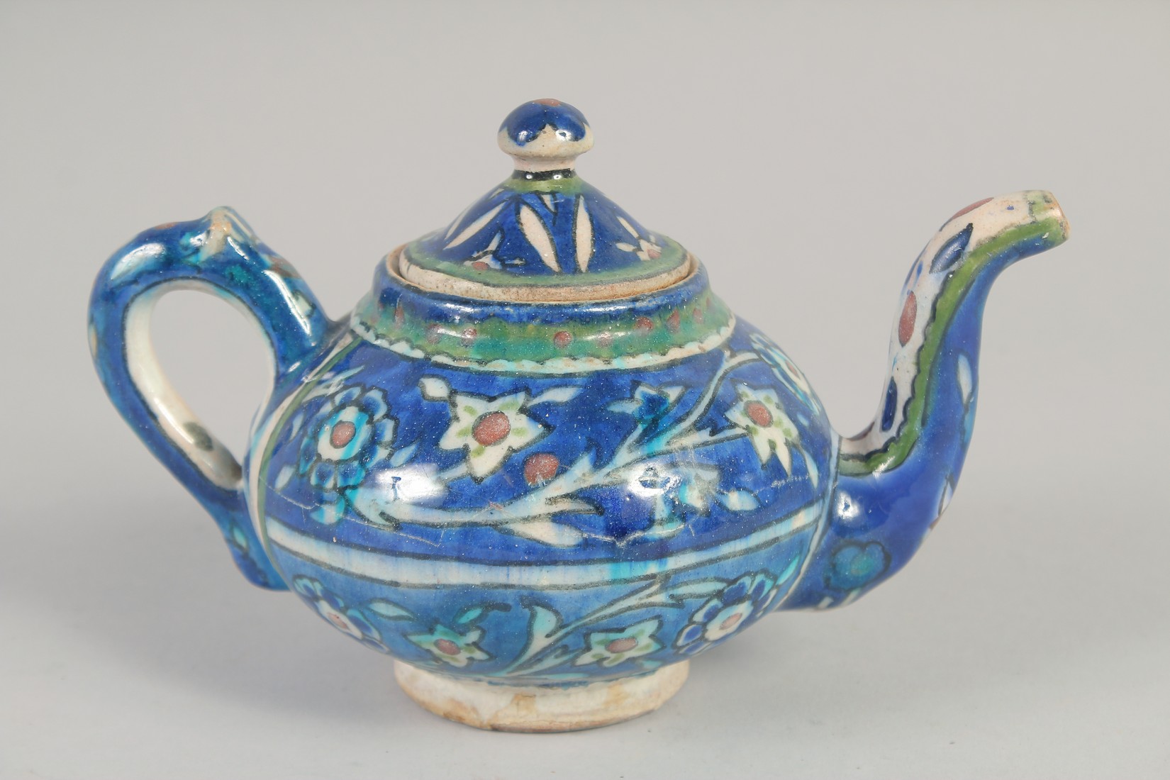 A PALISTINIAN GLAZED POTTERY TEAPOT, with foliate decoration, 19cm spout to handle. - Image 3 of 7