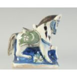 A 19TH CENTURY TURKISH KUTAHYA GLAZED POTTERY HORSE, 18cm long.