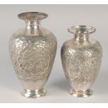 TWO PERSIAN WHITE METAL VASES, one drilled and weighted, 18cm and 15cm, (2).