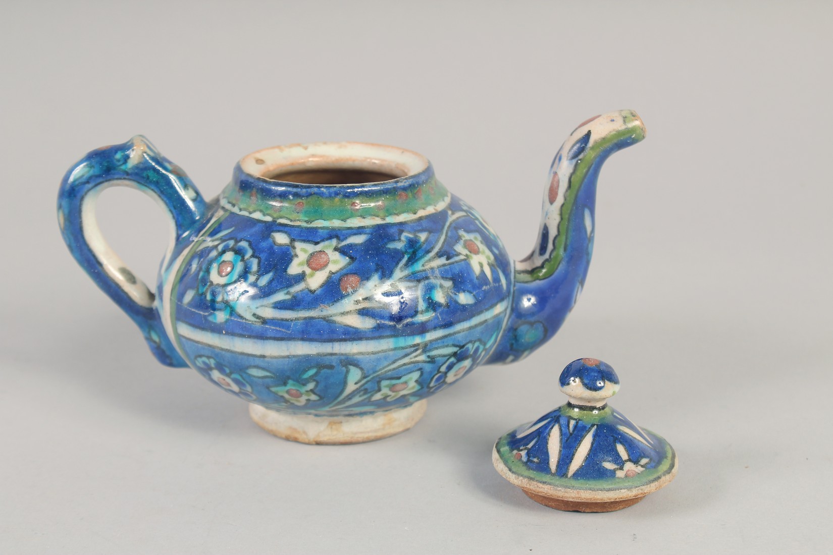 A PALISTINIAN GLAZED POTTERY TEAPOT, with foliate decoration, 19cm spout to handle. - Image 5 of 7