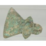 AN EARLY BRONZE AXE HEAD, with collar and triangular blade embellished with a heel in the shape of a