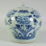 A 19TH CENTURY CHINESE BLUE AND WHITE JAR AND COVER, painted with flowers, butterfly and bats,