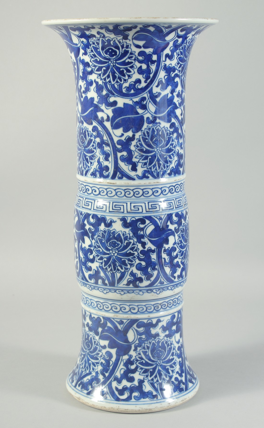 A LATE 19TH CENTURY CHINESE BLUE AND WHITE GU-FORM VASE, painted with floral motifs, 42cm high.