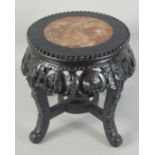 A CHINESE MARBLE INSET CARVED HARDWOOD STAND, 34cm high.