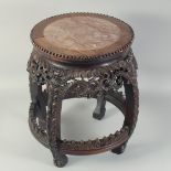 A CHINESE MARBLE INSET CARVED HARDWOOD BARREL-FORM VASE STAND, with carved and pierced foliate skirt