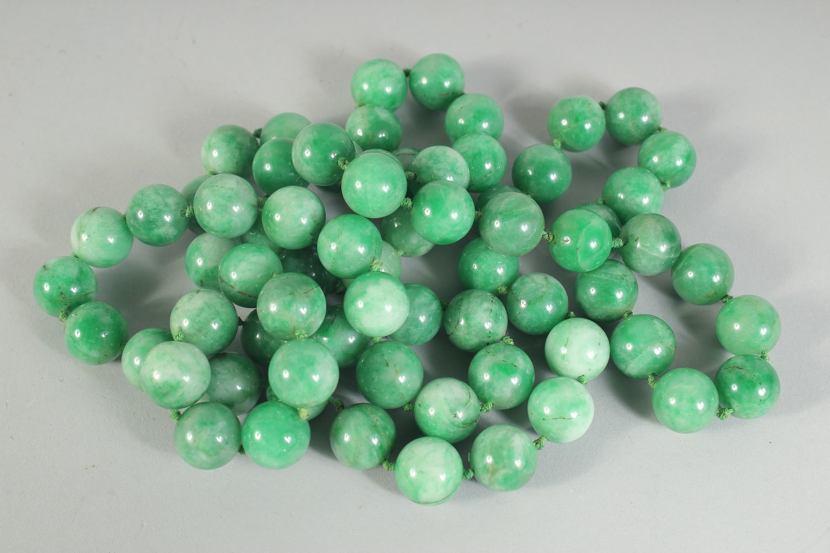 A GOOD APPLE-GREEN JADE BEADED NECKLACE.