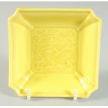 A SMALL CHINESE YELLOW GLAZED SQUARE FORM DRAGON DISH, 9.5cm square.