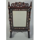 A 19TH CENTURY CHINESE MOTHER OF PEARL INLAID HARDWOOD MIRROR ON STAND, 45cm high, 24.5cm wide