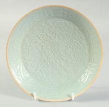 A CHINESE CARVED PEACOCK YINQING GLAZE DISH, 20.5cm diameter.
