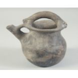 A 10TH CENTURY MIDDLE EASTERN UNGLAZED BLACK POT, with spout and handle, 17cm high.