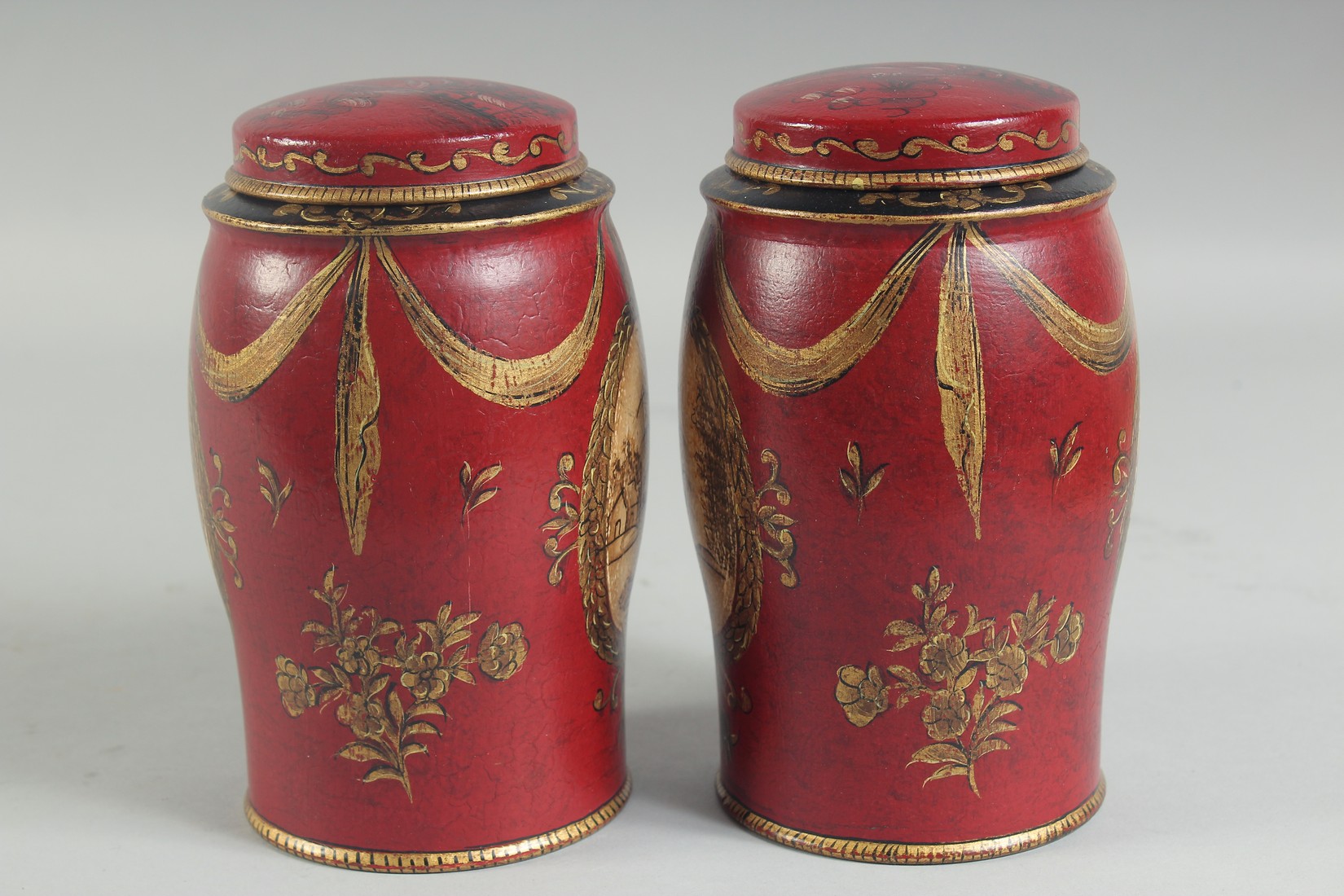 A SMALL PAIR OF RED TOLEWARE TINS AND COVERS. 7ins high. - Image 2 of 4