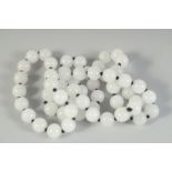 A STRING OF WHITE JADE BEADS. 30ins long.