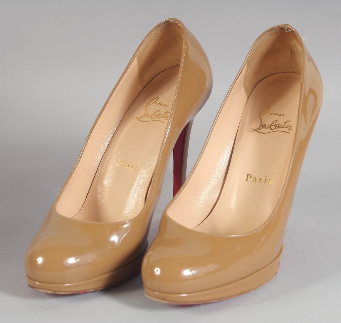 A PAIR OF CHRISTIAN LOUBOUTIN COFFEE COLOUR SHOES SIZE 37.