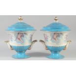 A PAIR OF CONTINENTAL LIGHT BLUE CUPID VASES AND COVERS. 11ins high.