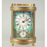 A 19TH CENTURY FRENCH BRASS CIRCULAR CARRIAGE CLOCK with enamel painted dial, raised trophies and