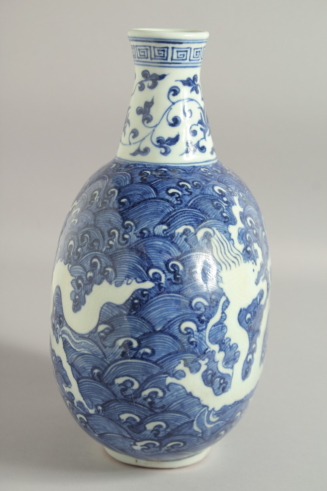 A CHINESE BLUE AND WHITE PORCELAIN MOON FLASK VASE, with incised white dragon on stylised waves, - Image 6 of 6