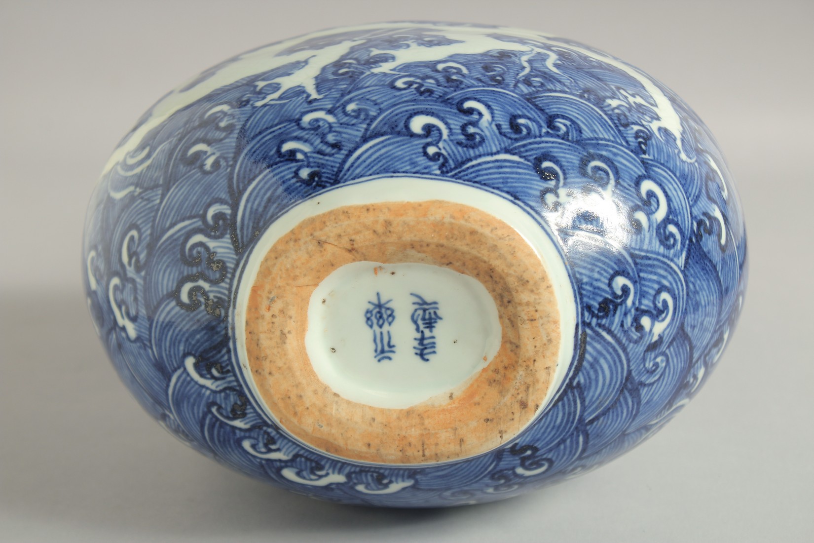 A CHINESE BLUE AND WHITE PORCELAIN MOON FLASK VASE, with incised white dragon on stylised waves, - Image 2 of 6