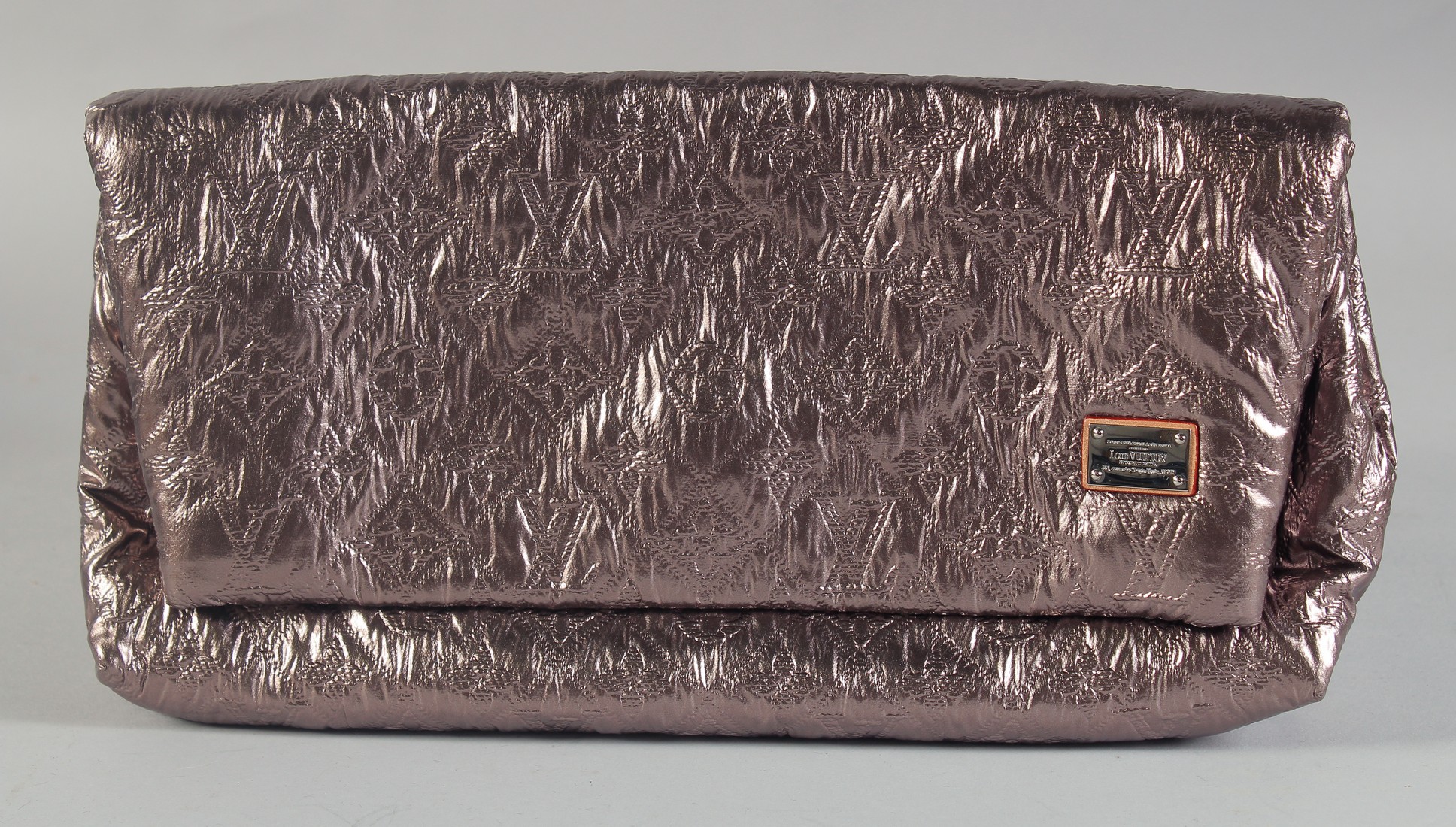 A LOUIS VUITTON FOLDING SILVER METALLIC CLUTCH BAG with folding front. 12ins long, 7ins deep, in