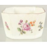 A CHELSEA PORCELAIN BUTTER PAT with canted corners and painted with flowers. 2ins.