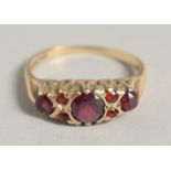 AN EDWARDIAN GOLD FIVE STONE RUBY RING.