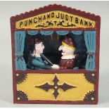 A CAST IRON PAINTED PUNCH AND JUDY BANK. 7ins high.