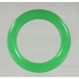 AN APPLE GREEN JADE BANGLE. 8cm diameter.