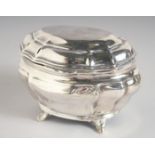 AN EDWARD VII BOMBE SHAPED SILVER TEA CADDY AND COVER. 4.75ins long, 3.5ins deep, supported on