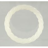 A WHITE JADE TWIST BANGLE.