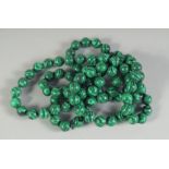 A STRING OF MALACHITE BEADS. 34ins long.