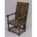 AN 18TH CENTURY OAK PANEL BACK ARMCHAIR with solid seat on stretchered turned legs. 3ft 6ins high