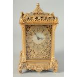 A GILT BRONZE CLOCK in an ornate case with elephant supports. 6ins high.