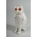 A SILVER PLATED OWL SUGAR SHIFTER with glass eyes. 6ins high.