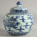 A LARGE CHINESE BLUE AND WHITE PORCELAIN JAR AND COVER, decorated with a dragon and stylised clouds,