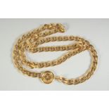 A LONG GILT METAL CHANEL CHAIN with medallions. 30ins long in a Chanel box.