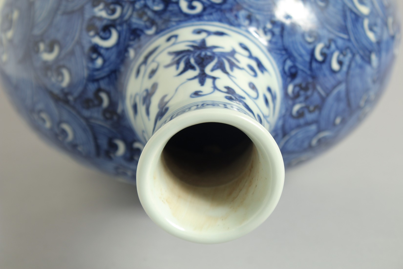 A CHINESE BLUE AND WHITE PORCELAIN MOON FLASK VASE, with incised white dragon on stylised waves, - Image 3 of 6