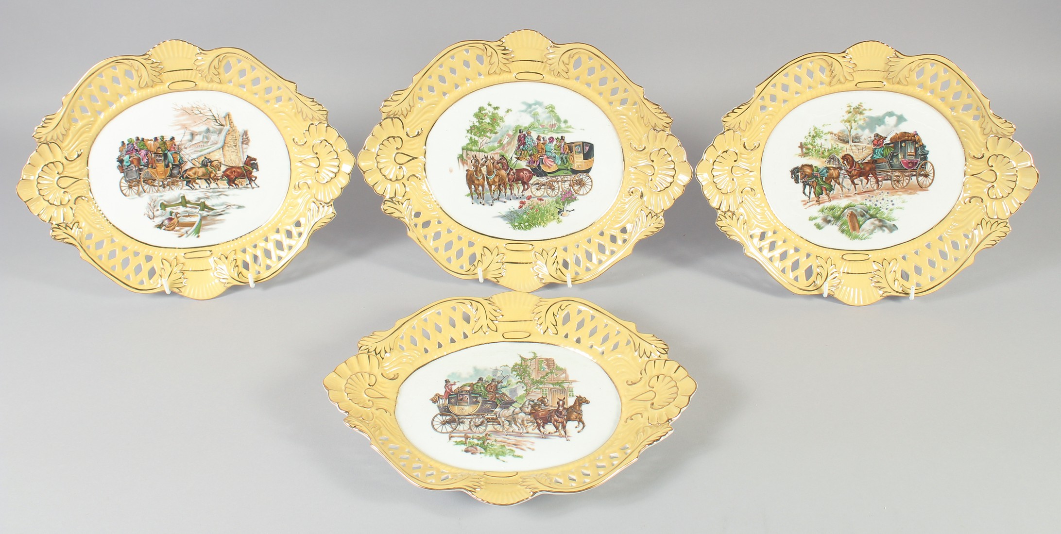 A SET OF FOUR CONTINENTAL YELLOW GROUND OVAL STAGECOACH DISHES. 12ins wide.