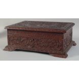 A GOOD 19TH CENTURY WOODEN BOX the top carved with a peacock. 14ins wide.