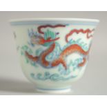 A CHINESE DOUCAI PORCELAIN DRAGON CUP, 6.5cm diameter.